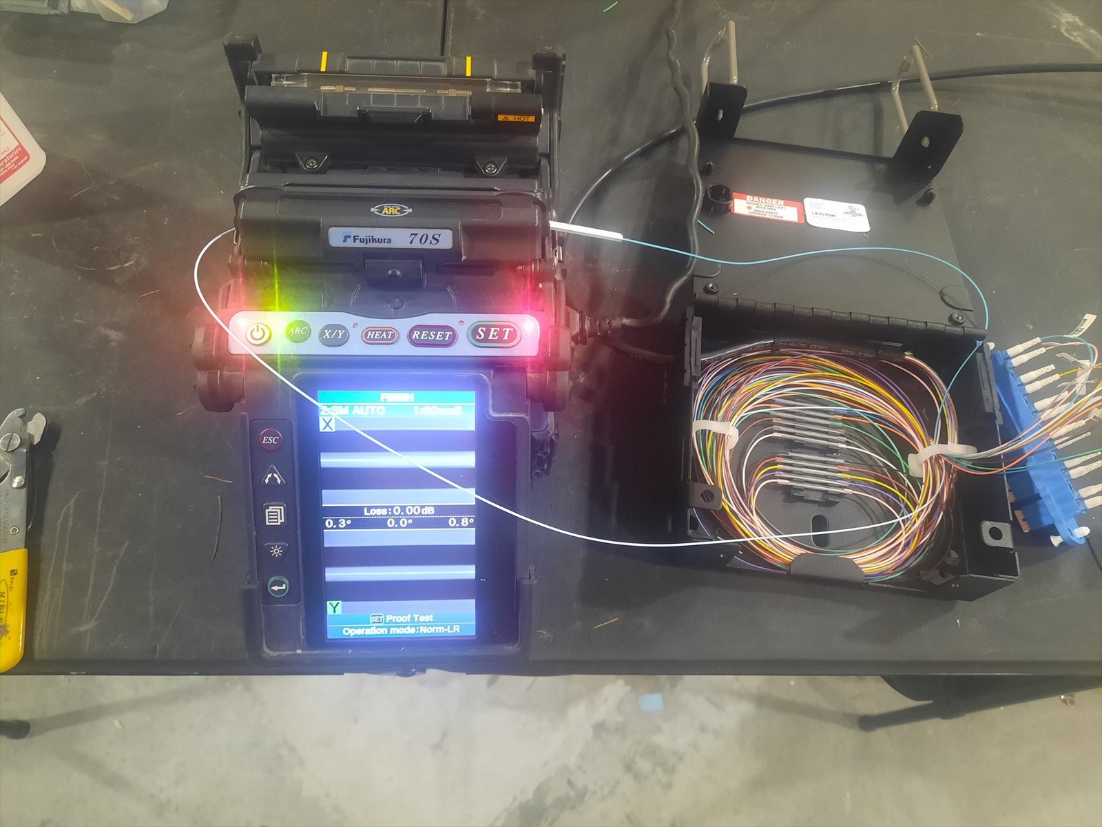 Technician performing fiber optic fusion splicing
